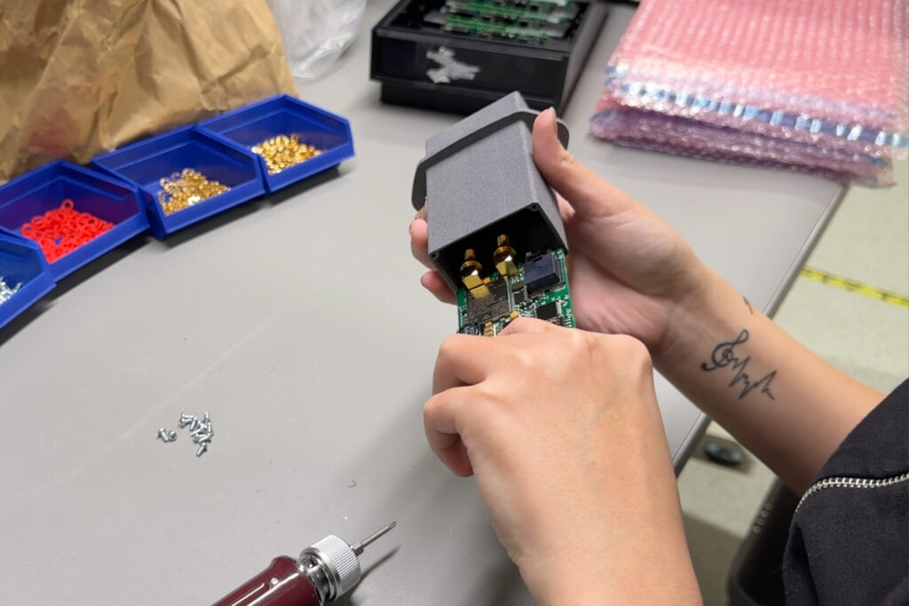 Mounting completed PCBs into enclosures for final delivery.